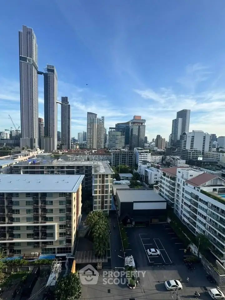 Stunning cityscape view showcasing modern high-rise buildings and urban skyline under a clear blue sky.
