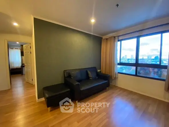 Spacious living room with city view and modern furnishings