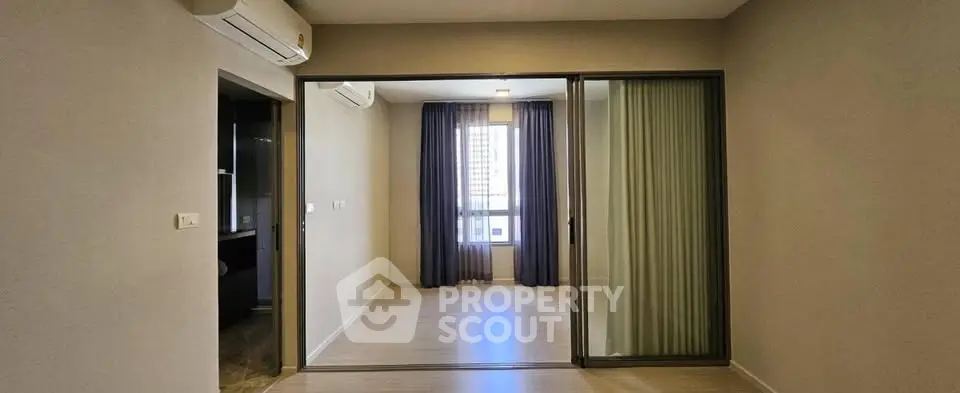 Spacious modern living room with sliding glass doors and natural light