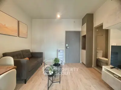 Modern living room with stylish decor and open layout, featuring cozy seating and elegant furnishings.
