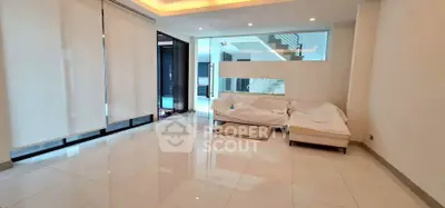 Spacious modern living room with sleek design and large windows for natural light.