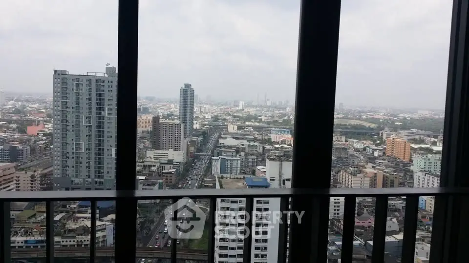 Stunning cityscape view from high-rise building balcony, showcasing urban skyline and bustling streets.