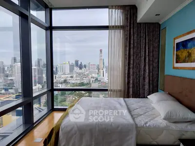 Luxurious bedroom with panoramic city view in high-rise apartment