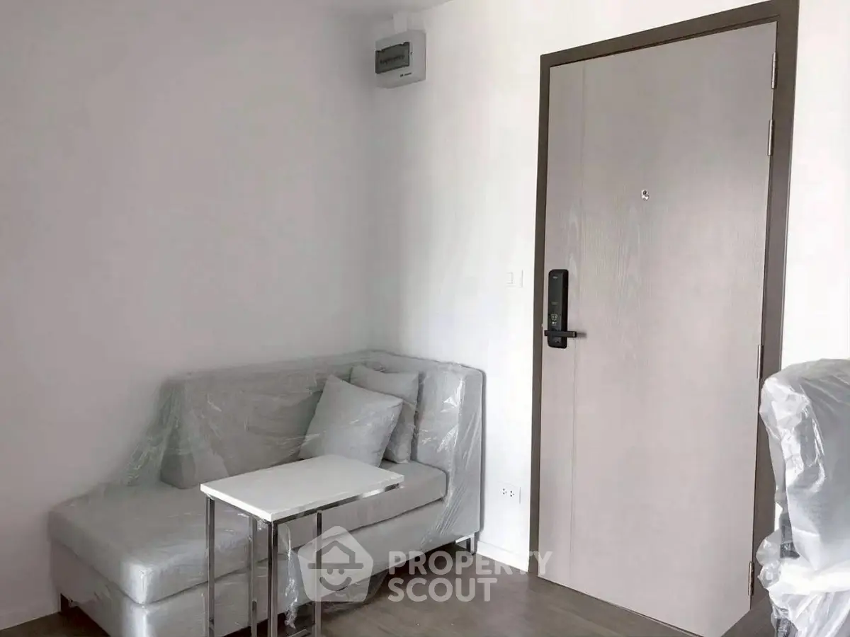 Modern minimalist living room with sleek sofa and stylish door
