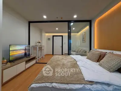 Modern bedroom with cozy lighting and stylish decor in a contemporary apartment.