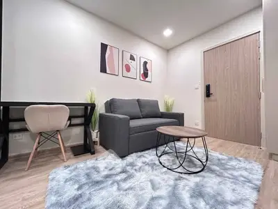 Modern living room with stylish decor, cozy sofa, and elegant coffee table on plush rug.