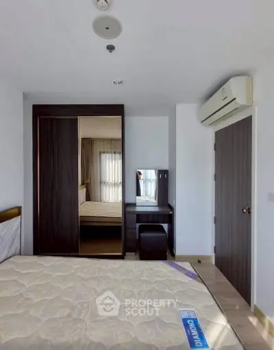 Modern bedroom with mirrored wardrobe and air conditioning in a stylish apartment.