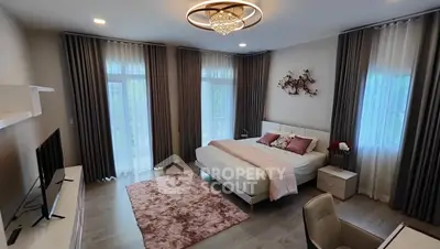 Luxurious bedroom with elegant decor and large windows for natural light