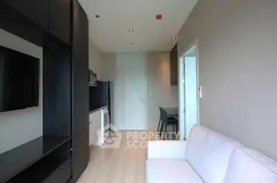 Modern living room with sleek furniture and open kitchen layout