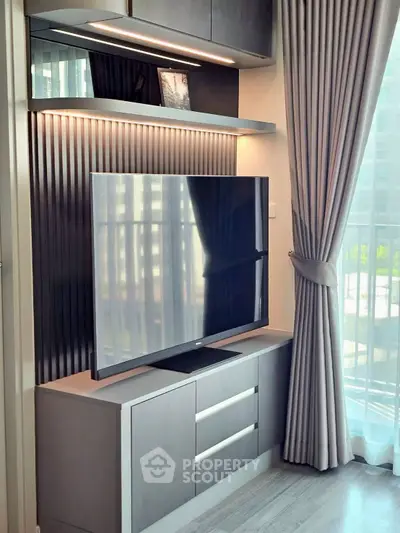 Modern living room with sleek TV setup and elegant curtains