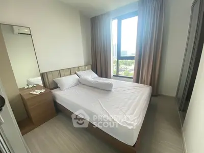 Modern bedroom with large window and minimalist decor in a high-rise apartment.