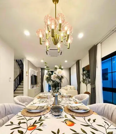 Elegant dining room with modern chandelier and stylish decor in a contemporary home.