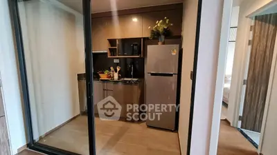 Modern compact kitchen with sleek appliances and stylish cabinetry