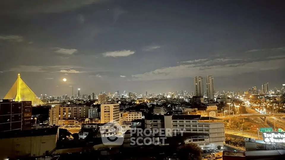 Stunning cityscape view with illuminated skyline and iconic bridge at night.