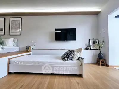 Modern living room with sleek furniture and wall-mounted TV