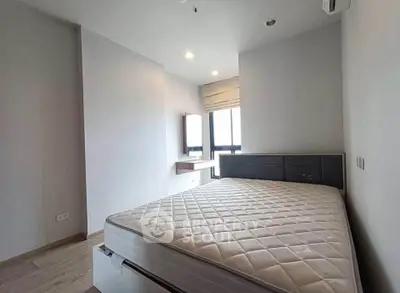 Spacious bedroom with modern design and large windows offering natural light.