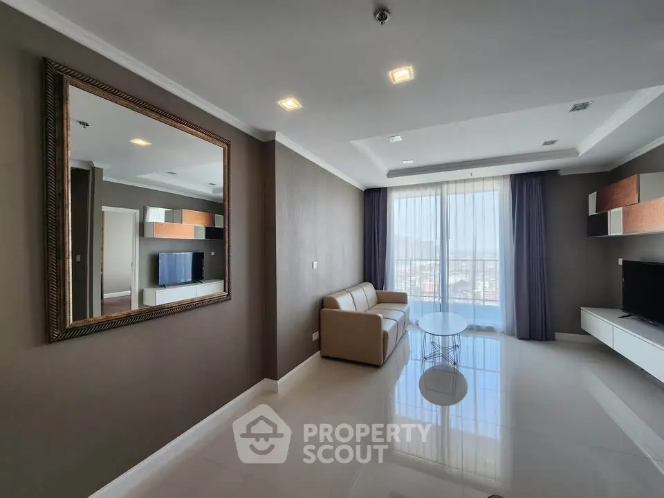 Spacious modern living room with large mirror and city view, perfect for relaxation and entertainment.