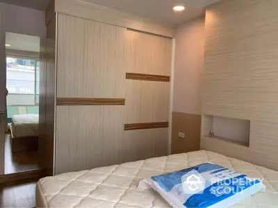 Modern bedroom with stylish wardrobe and comfortable mattress in cozy apartment