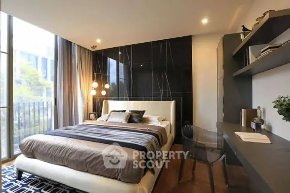 Luxurious modern bedroom with elegant decor and large windows offering natural light.
