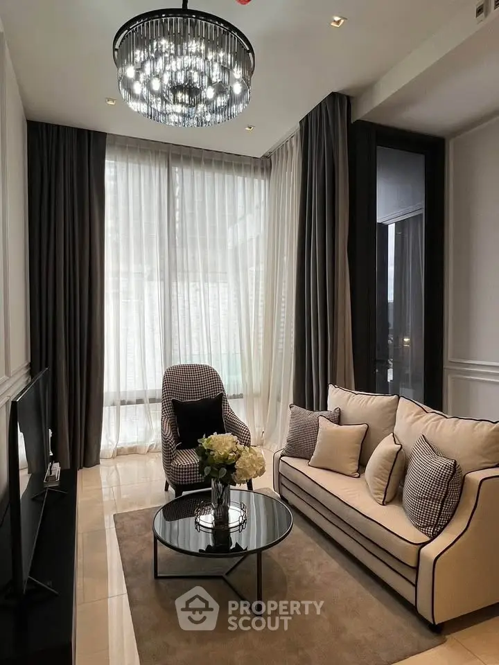 Elegant living room with modern chandelier and cozy seating area