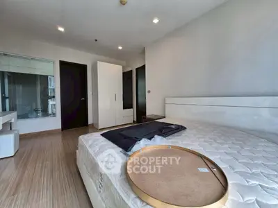Spacious modern bedroom with sleek design and ample natural light