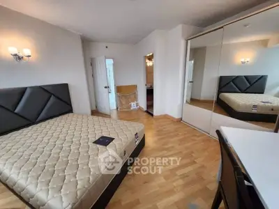 Spacious bedroom with modern design and mirrored wardrobe