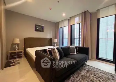 Luxurious bedroom with modern decor and large windows in high-rise apartment