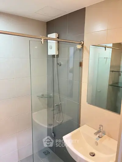 Modern bathroom with glass shower enclosure and sleek fixtures