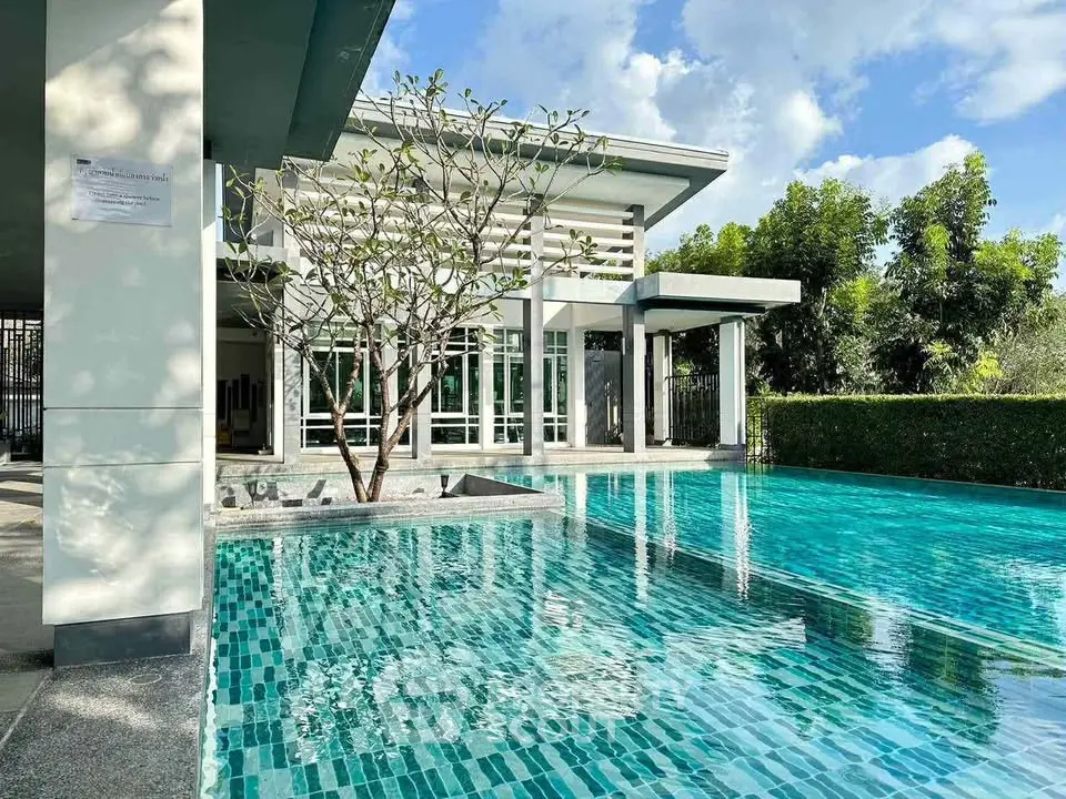 Luxurious modern home with stunning pool and lush greenery, perfect for relaxation and entertainment.