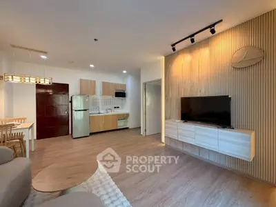 Modern open-plan living room with stylish kitchen and cozy dining area