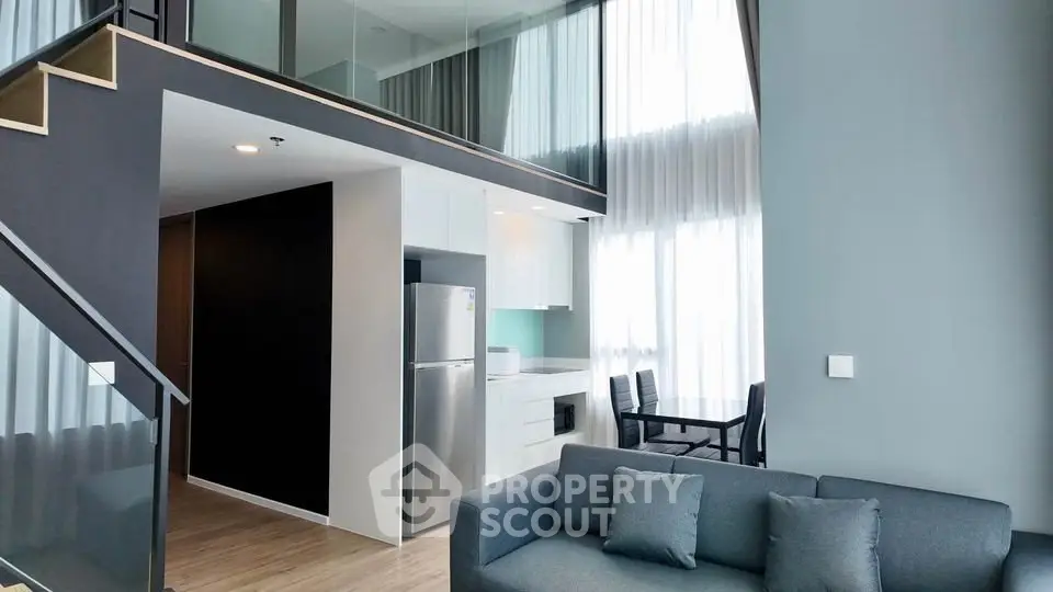 Modern loft apartment with high ceilings, sleek kitchen, and stylish living area.