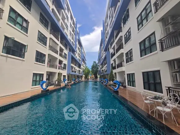 Luxurious apartment complex with stunning pool and modern architecture.