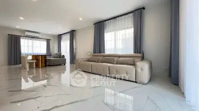 Spacious modern living room with elegant marble flooring and stylish furniture.
