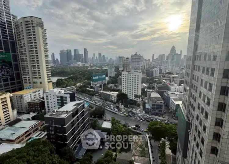 Stunning cityscape view from high-rise building with skyline and sunset.