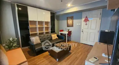 Cozy living room with modern furniture and wooden flooring in a stylish apartment.