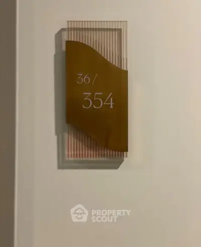Stylish apartment number plaque with modern design and clear numbering for easy identification.