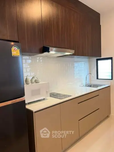 Modern kitchen with sleek cabinetry and built-in appliances