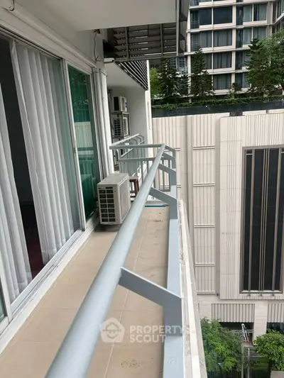 Modern apartment balcony with city view and air conditioning unit