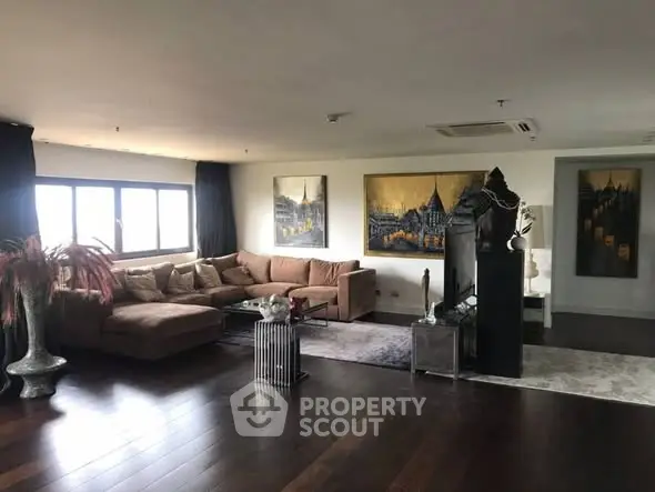 Spacious living room with modern decor and large windows for natural light.