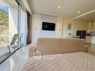 Luxurious living room with stunning view and modern decor, featuring a cozy sofa and wall-mounted TV.