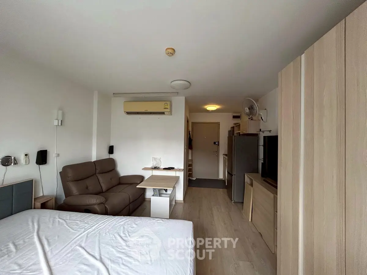 Modern studio apartment with cozy living area and sleek furnishings