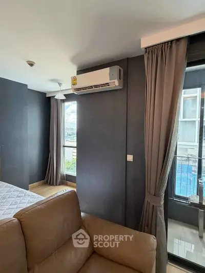 Modern bedroom with air conditioning and balcony view in a stylish apartment.