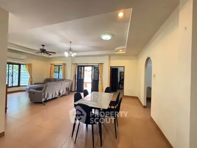 Spacious open-plan living and dining area with modern furnishings and ample natural light.