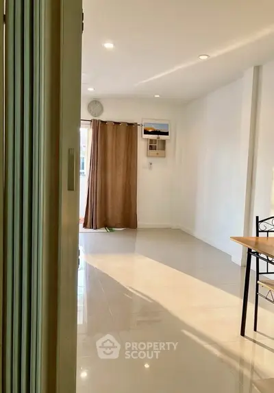 Spacious and bright living area with modern decor and natural light.