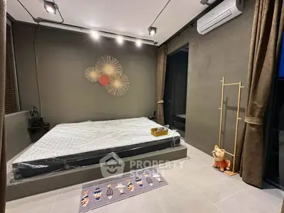 Modern bedroom with minimalist design and stylish wall art, featuring a platform bed and air conditioning.
