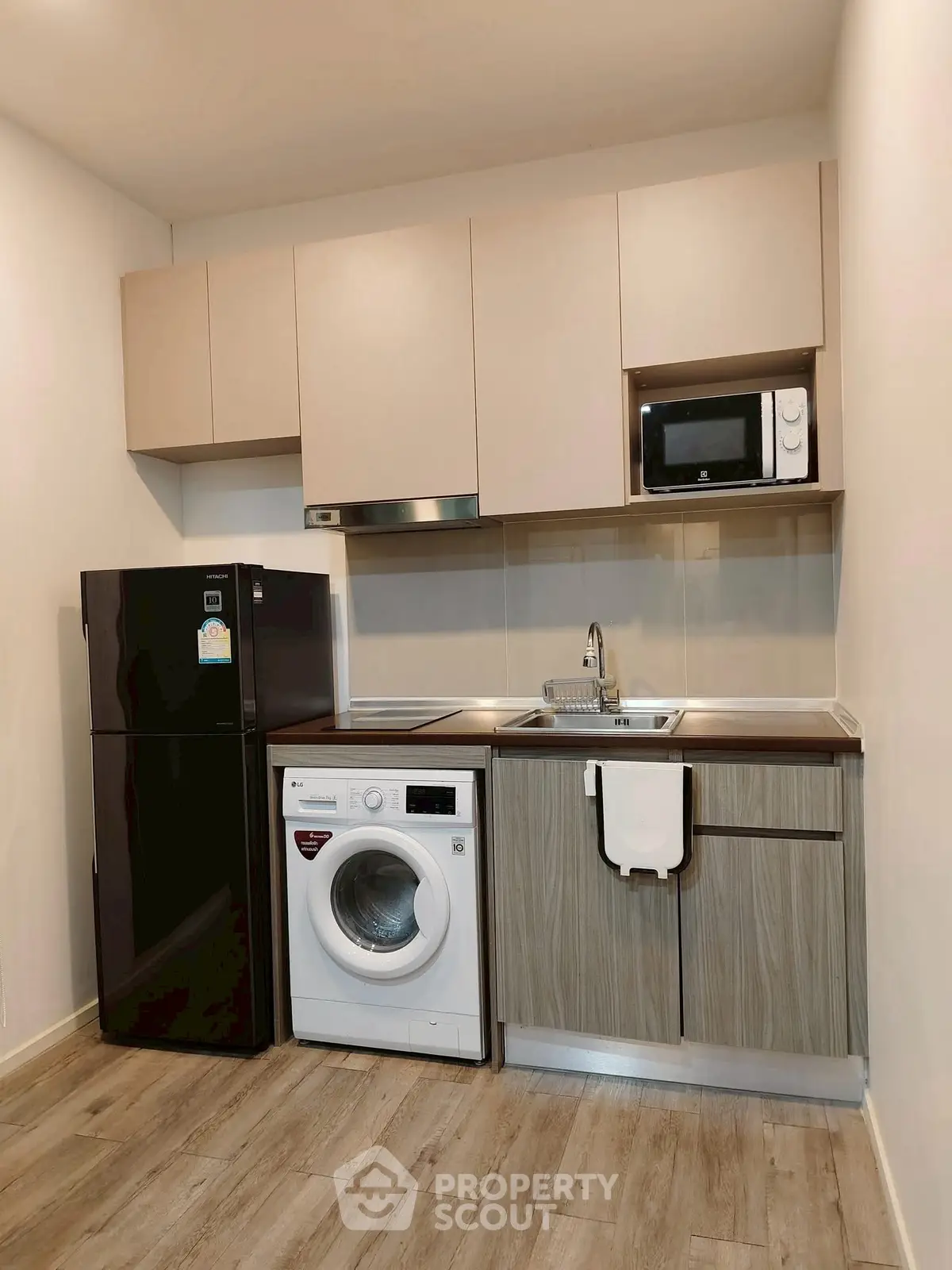 Modern compact kitchen with washing machine and microwave