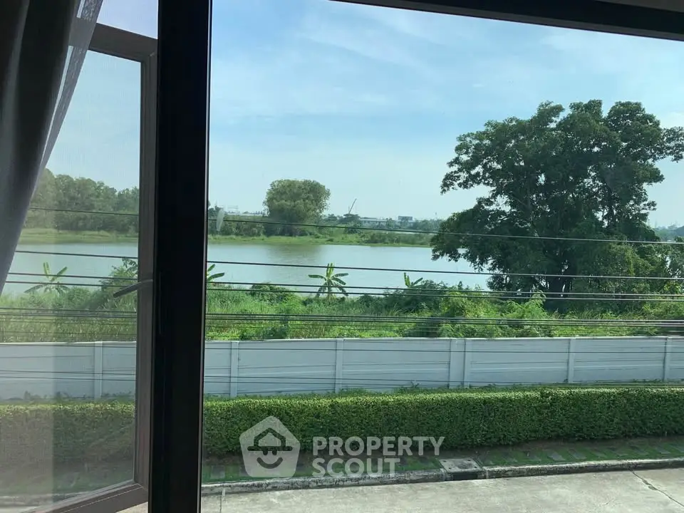 Stunning lake view from window with lush greenery and serene ambiance