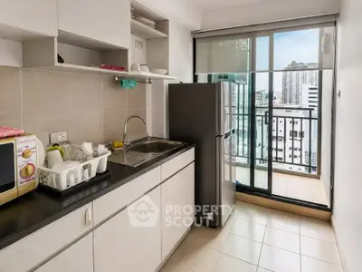 Modern kitchen with balcony view in urban apartment