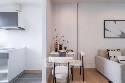 Modern open-plan living room and kitchen with stylish decor and cozy seating area.