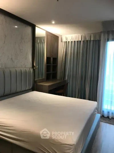 Spacious bedroom with elegant decor and natural light